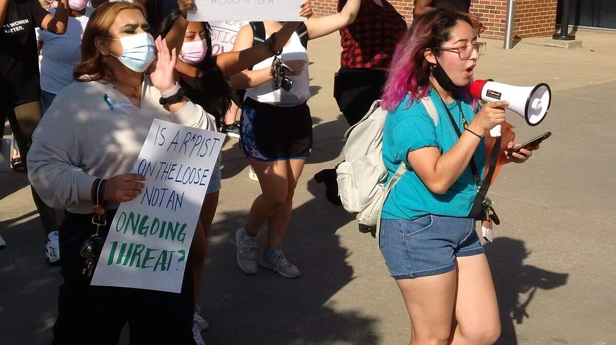 Wichita State University students Rija Nazir, left and Alondra Aguilera lead a march protesting campus police handling of a reported rape in the Shocker Hall dormitory.