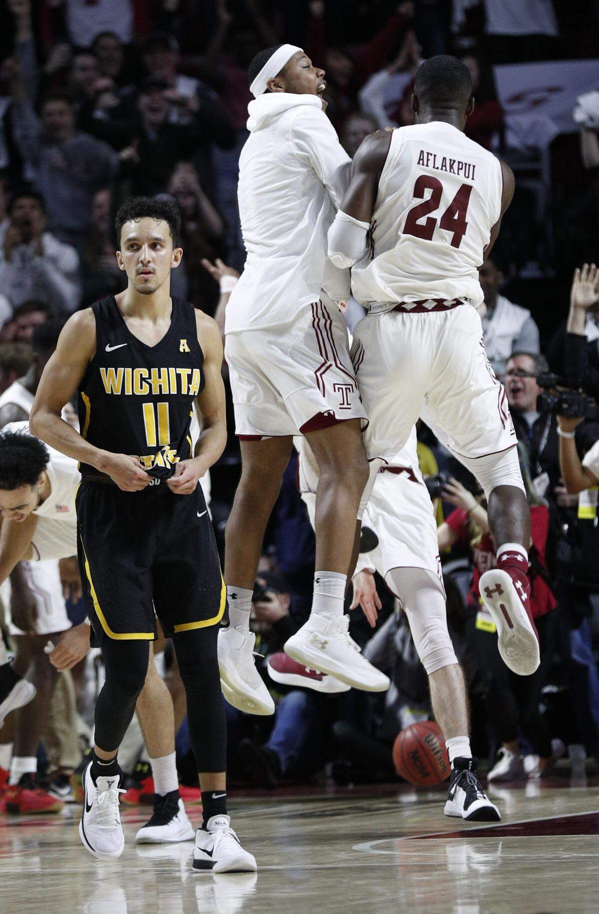 Wichita State's Landry Shamet looks away as Temple's Ernest Aflakpui, right, celebrates the win with teammates Feb. 1, in Philadelphia.