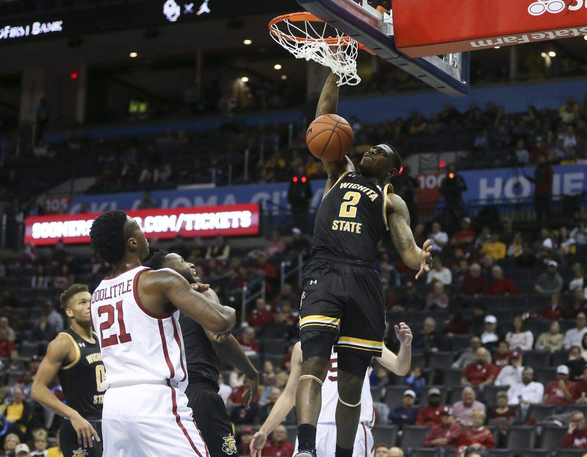 Wichita State guard Jamarius Burton dunks over Oklahoma forward Kristian Doolittle during the second half of their game at Chesapeake Energetic Arena in Oklahoma City on Saturday.