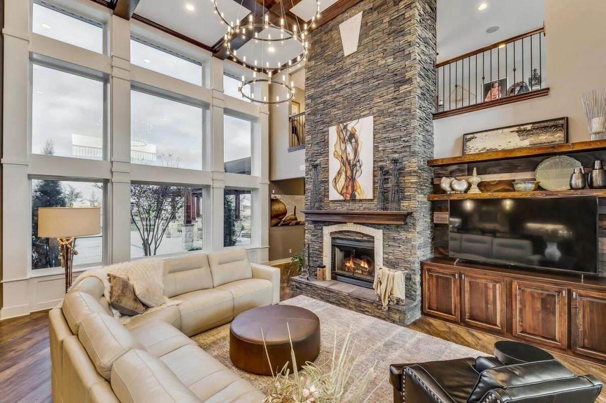 The living room in 7053 S. 143rd St. E. features a two-story stone fireplace.