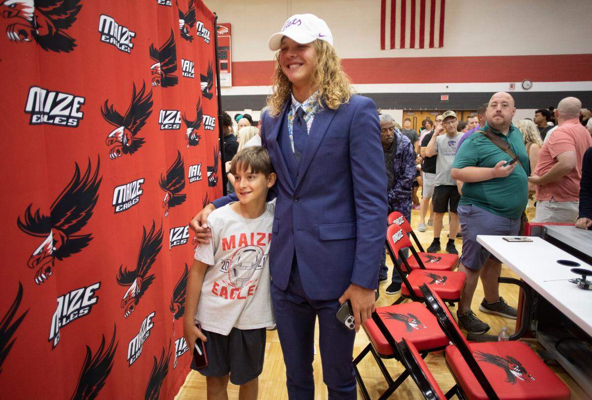 Avery Johnson poses for pictures on Tuesday at Maize High after the announced his commitment to Kansas State.
