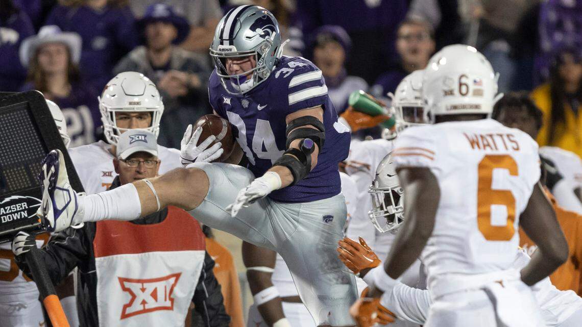 Kansas State’s Ben Sinnott hurdles a Texas defender during the first quarter on Saturday in Manhattan.