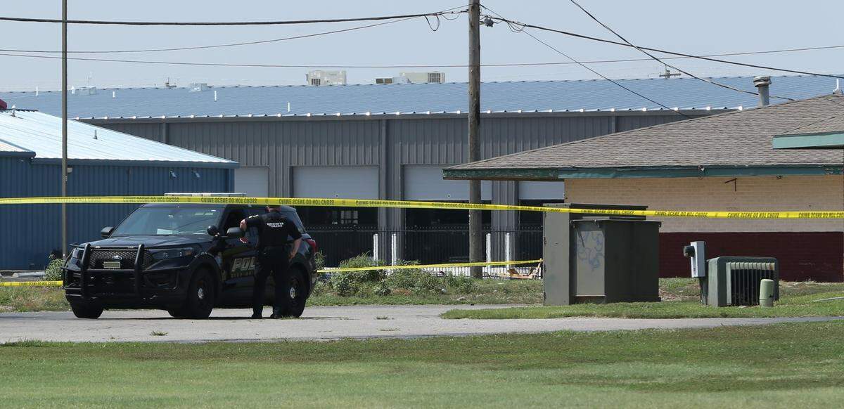 Police had the parking lot of the Delux Inn motel taped off Wednesday. Authorities think a man was killed there. His body was found inside a car trunk a quarter-mile away in a grassy field.