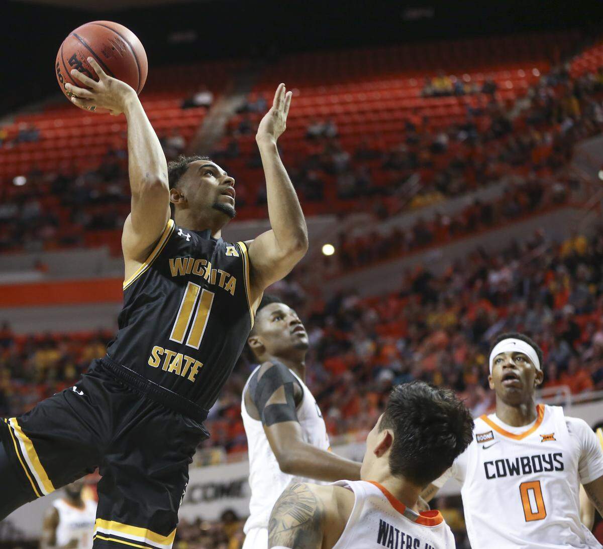Wichita State’s Noah Fernandes shoots the ball against Oklahoma State’s Lindy Waters during the first half of their game in Stillwater on Sunday.