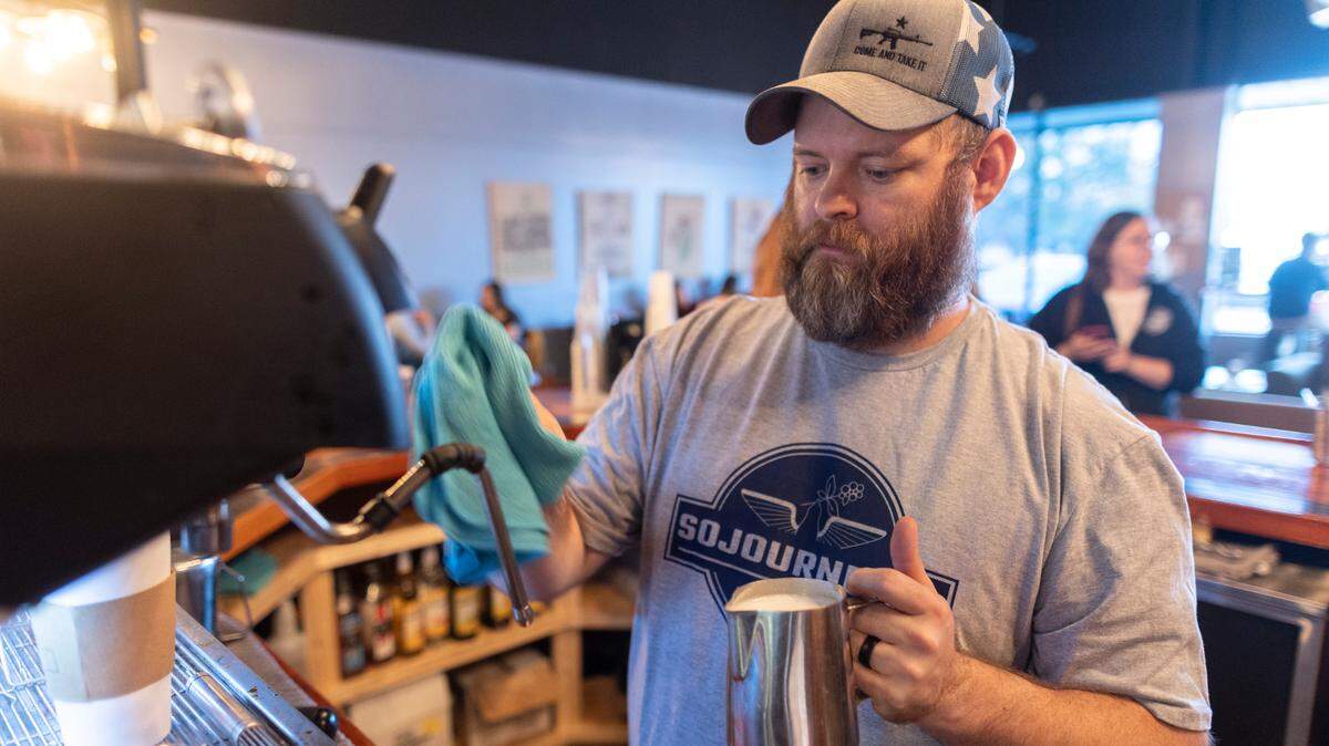 Larry King prepares a latte at Sojourner’s Coffee House near Maple and Ridge. King and his wife, Ashley, opened the coffee store in hopes of helping veterans.