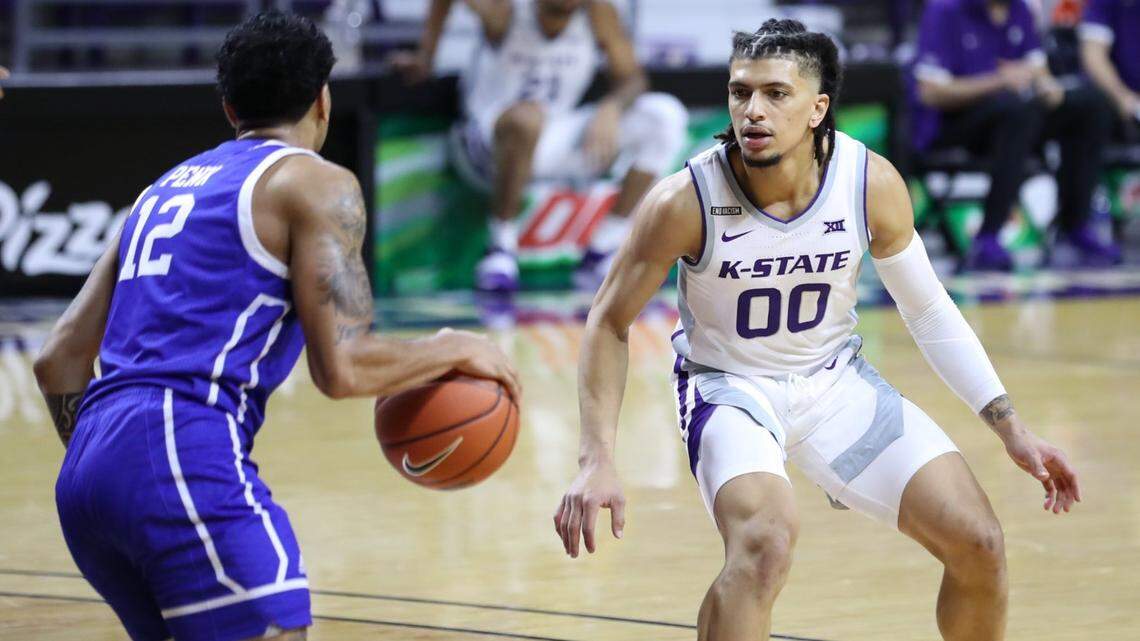Kansas State senior Mike McGuirl defends against Drake guard Roman Penn in the first game of the Little Apple Classic on Wednesday at Bramlage Coliseum.
