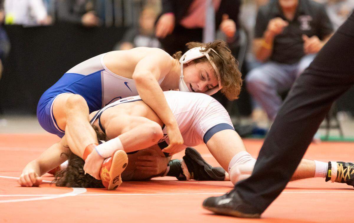 Kapaun Mt. Carmel’s Bubba Wright gains top control in his 5A title match, which he won for the second straight year.