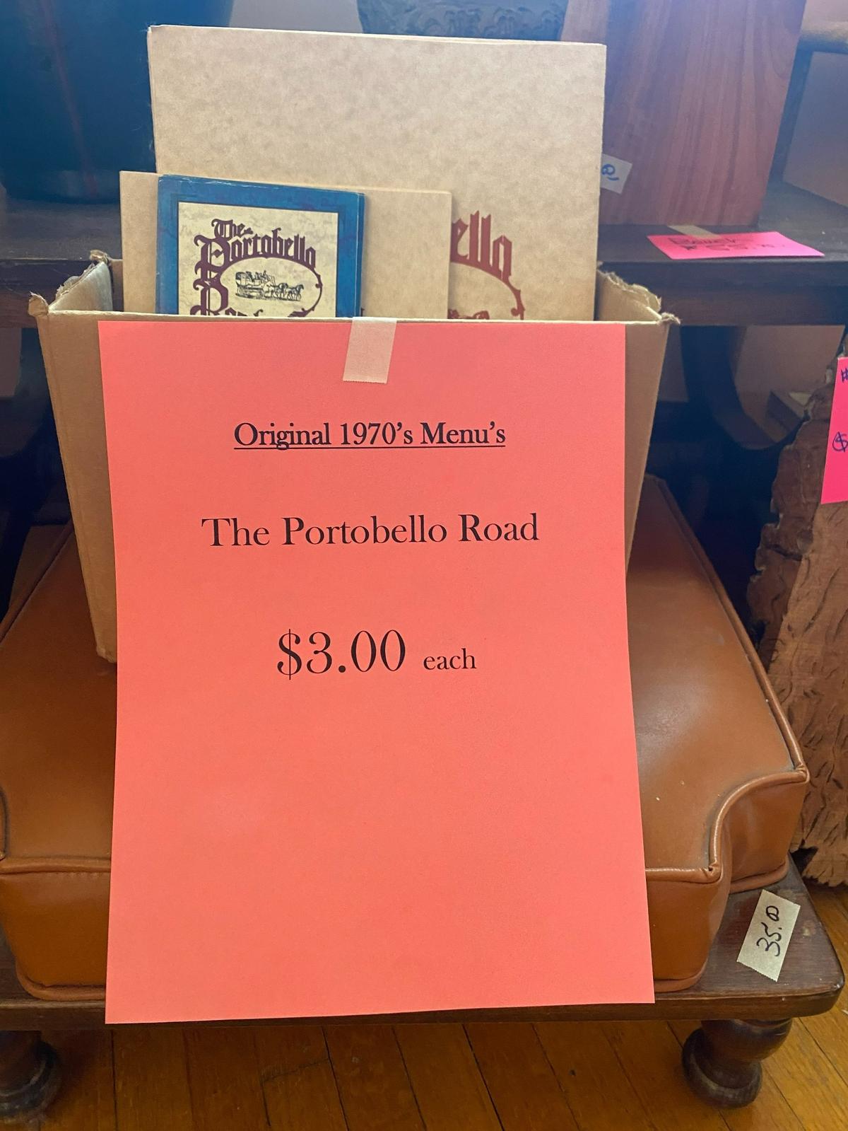 An estate sale near Kellogg and Edgemoor has a vintage Portobello Road restaurant sign for sale as well as a box of menus from the 1990s.