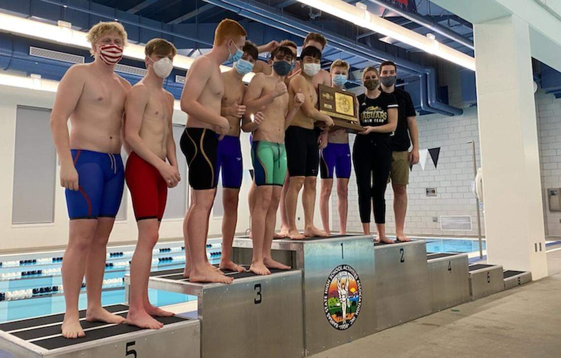 The Andover Central boys swimming team celebrates its first team state championship in school history.