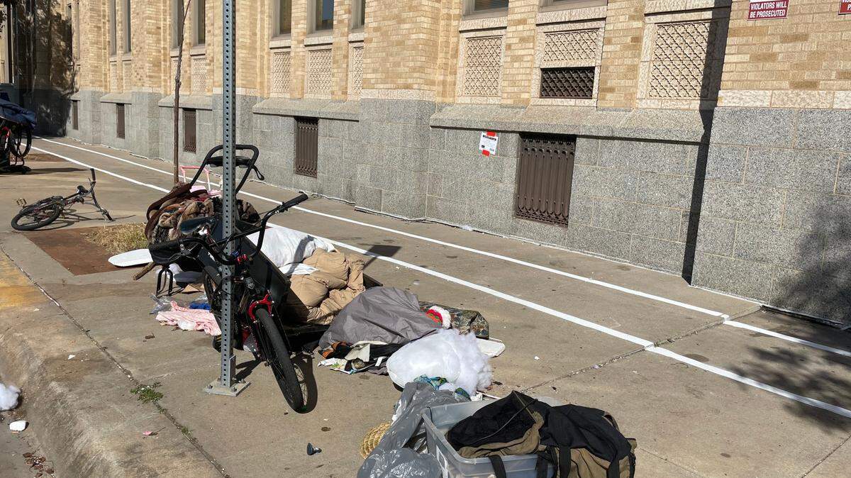 At the direction of the Wichita Police Department, white lines were painted on a sidewalk at Second and Topeka in downtown Wichita. Police say business owners have complained in recent months of increased violence and drug use at the homeless encampment near United Methodist Open Door day shelter.
