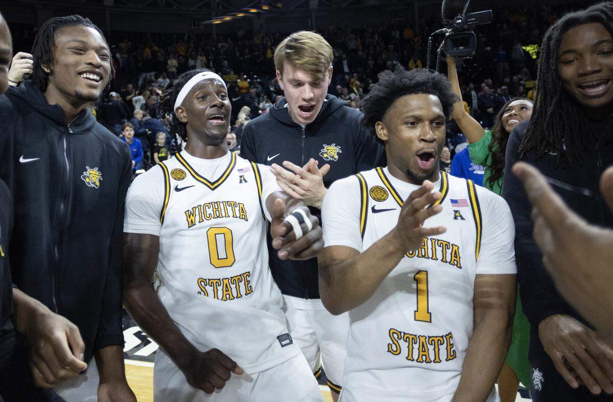 Karon Boyd (0) and Kenyon Giles (1) celebrate after they led a second-half comeback against Tulsa at Koch Arena on Saturday night.