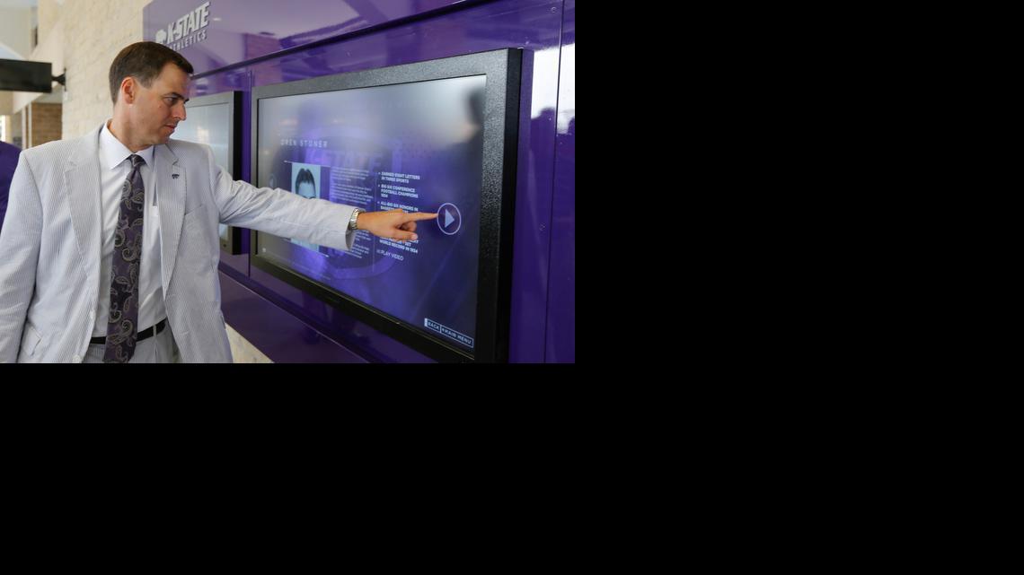 Kansas State athletic director John Currie demonstrates an interactive video display at the expanded west section of Snyder Family Stadium last August.

