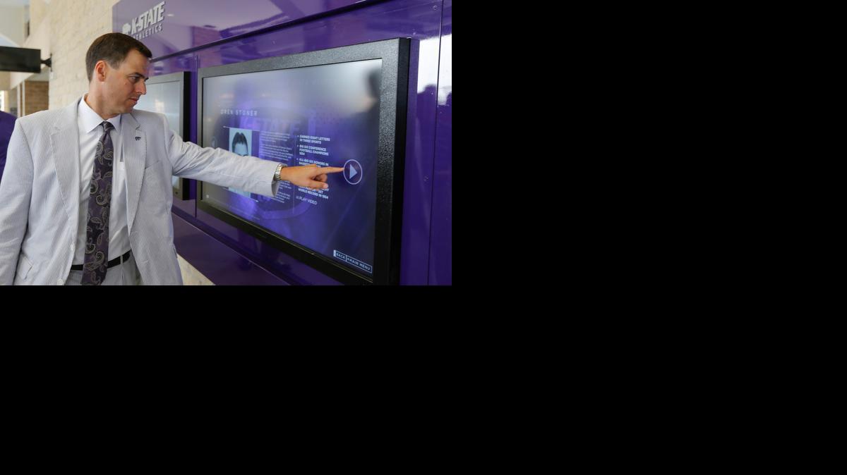 Kansas State athletic director John Currie demonstrates an interactive video display at the expanded west section of Snyder Family Stadium last August.

