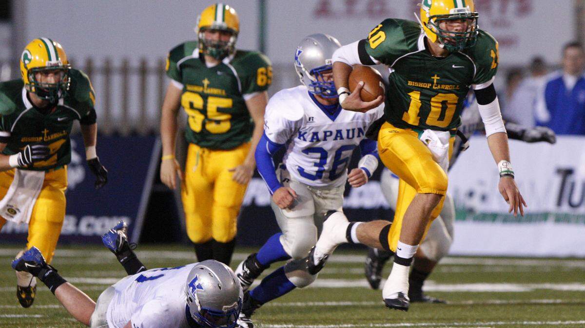 Bishop Carroll’s Blake Bell runs up the middle against Kapaun in the 1st quarter Friday