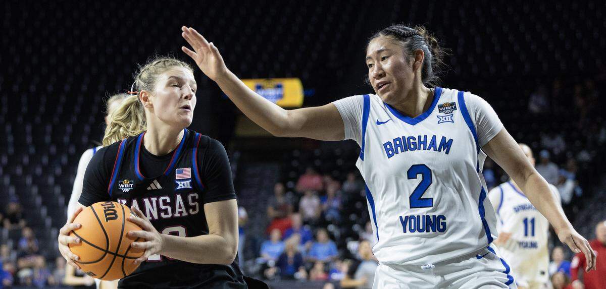 Kansas’ Libby Fandel tries to get past BYU’s Sydney Benally during the first half of their WBIT semifinal game at Wichita’s Koch Arena on Monday.
