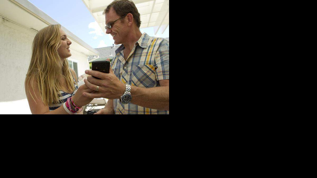 
Will MacDonald, right, and his daughter Kendall MacDonald, 15, are amused by a photo they just posted onto Instagram during a family birthday party in Sunnyvale, Calif.
