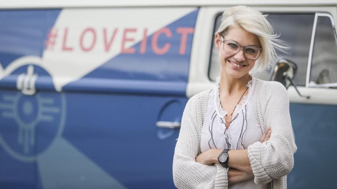 Janelle King, owner of the Workroom, stands in front of a vintage Volkswagen bus out of which she sells Wichita-centric merchandise.