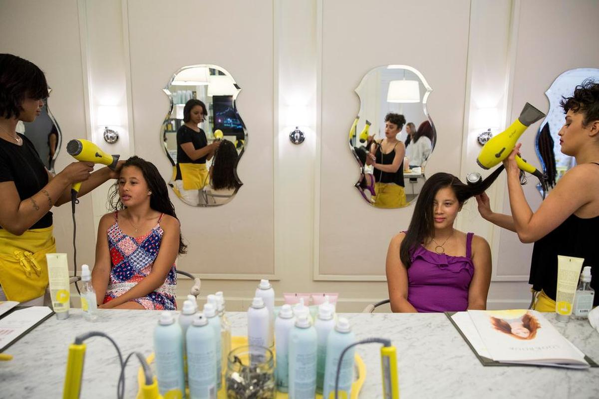  From left, sisters Avery Sion, 12, and Shea Sion, 16, get their hair done at Drybar in Bethesda, Md. The new popular hairstyle with America’s youth is long, straight and flowing. 