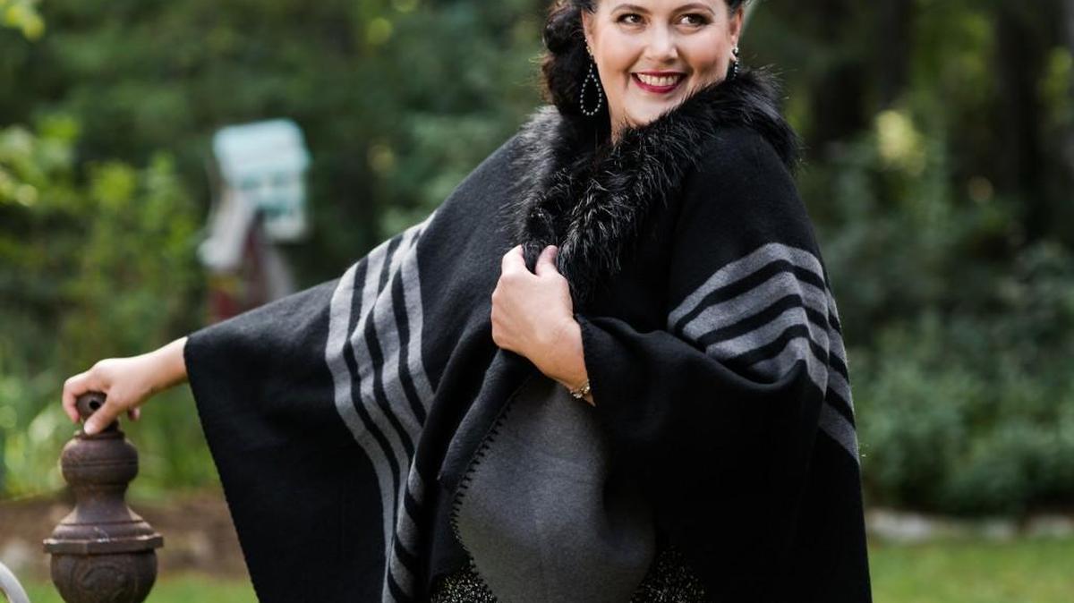 Ponchos will be replacing a lot of jackets this fall. The gray and black poncho pictured is soft acrylic with detachable fur collar, $60, at The First Place. Photographed at the Bartlett Arboretum.