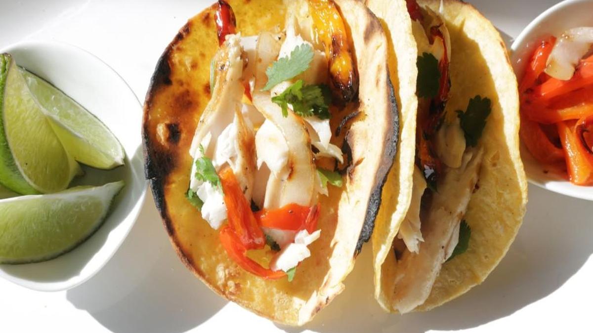 Grilled Mahi tacos with grilled peppers and onions are quick and simple to make.