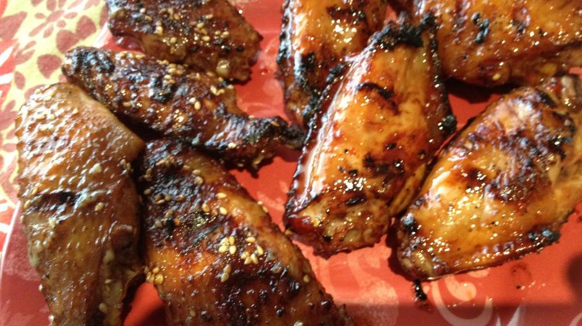 Korean BBQ Wings, left, and Sweet Chile Wings will make your backyard barbecue soar this summer.