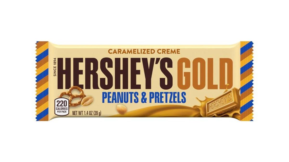 This image released by the Hershey Co. shows its new candy bar Hershey’s Gold that will go on sale Dec. 1, 2017. It is described as a caramelized cream bar embedded with salty peanut and pretzel bits.