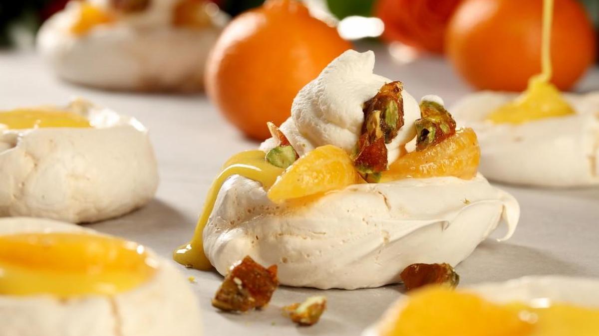 Meringues loaded with clementine curd and whipped cream and topped with candied pistachios.