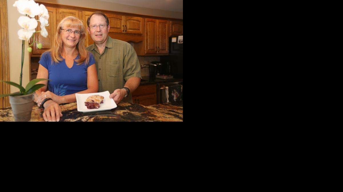 
Janne and Greg Rowe in their kitchen with a blueberry pudding cake. (September 17, 2014) 
