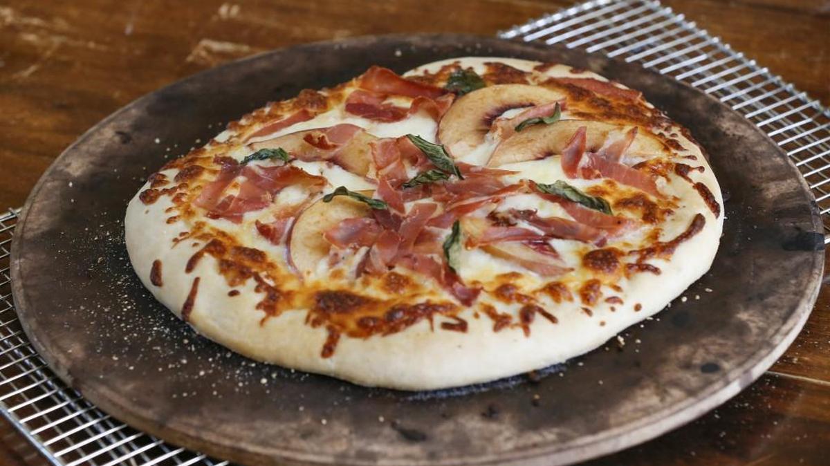 Peaches and prosciutto top this simple summer pizza.