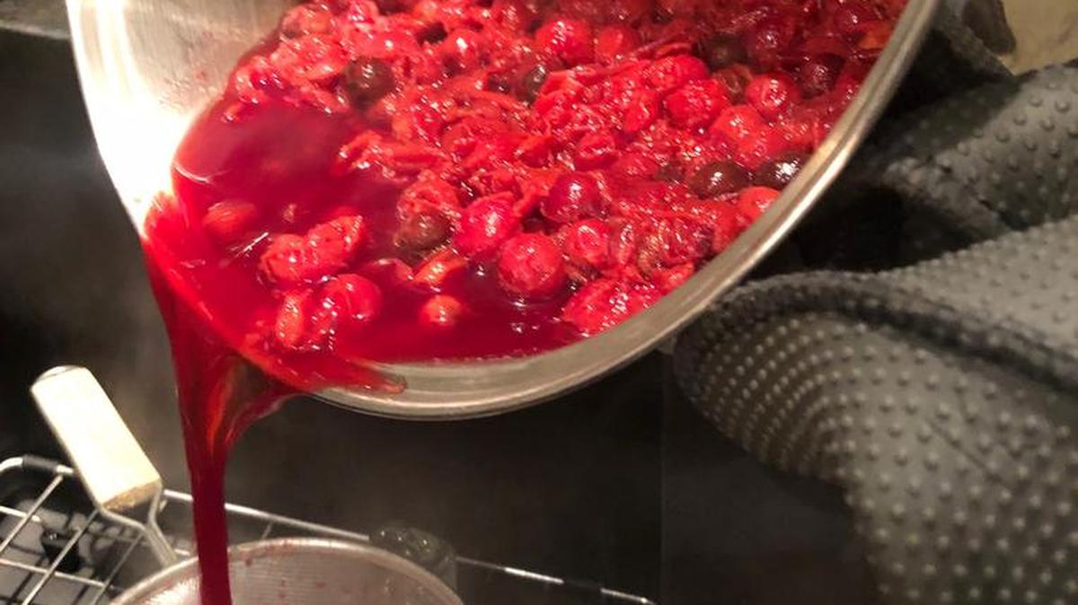 Strain boiled sand plums to make juice for your jelly.