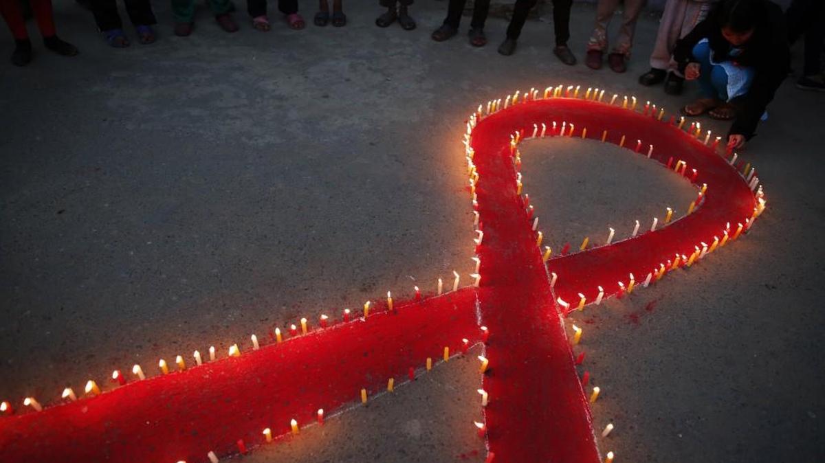 Nepalese women and children from Maiti Nepal, a rehabilitation center for victims of sex trafficking, light candles on Wednesday, the eve of World AIDS Day in Kathmandu, Nepal.