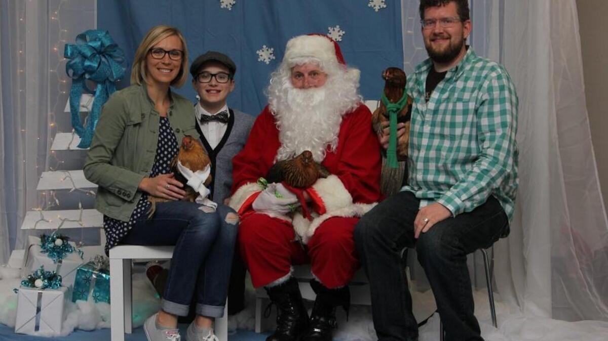 From left, Lacy, Judah and Kenton Hansen pose with Santa Claus and their three pet chickens – Buckley, April Roberta Ludgate-Dwyer and Henrietta – at a fundraiser for the Kansas Humane Society.