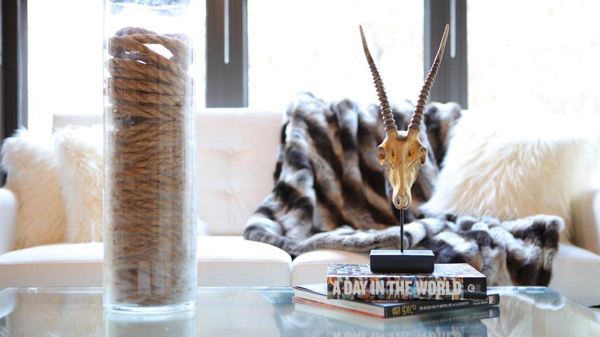 Basic jute rope from a hardware store wrapped inside a tall glass vessel creates an organic and industrial-inspired tabletop item.