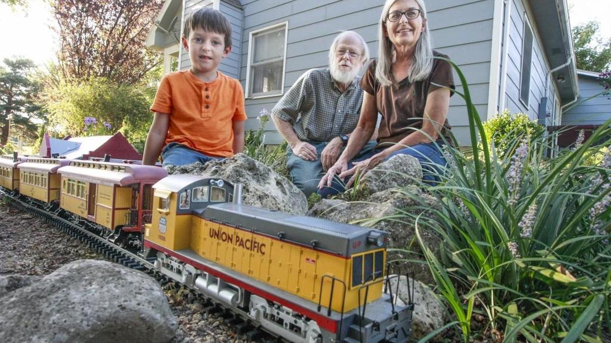 Nick and Bonnie Roark pose with their grandson, Kyle Hobbs, 5, in their garden railway in Augusta on Wednesday. (Sept. 6, 2017)