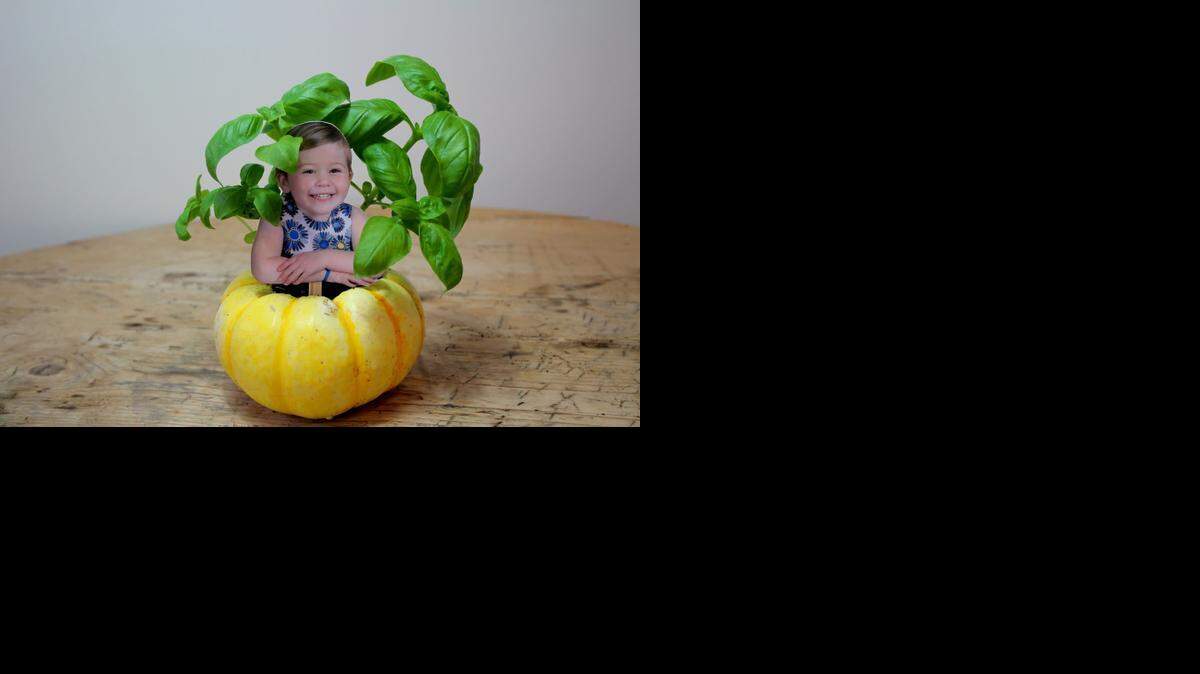 
Gut mini squashes and fill them with herbs and a photo of guests to use as place cards.
