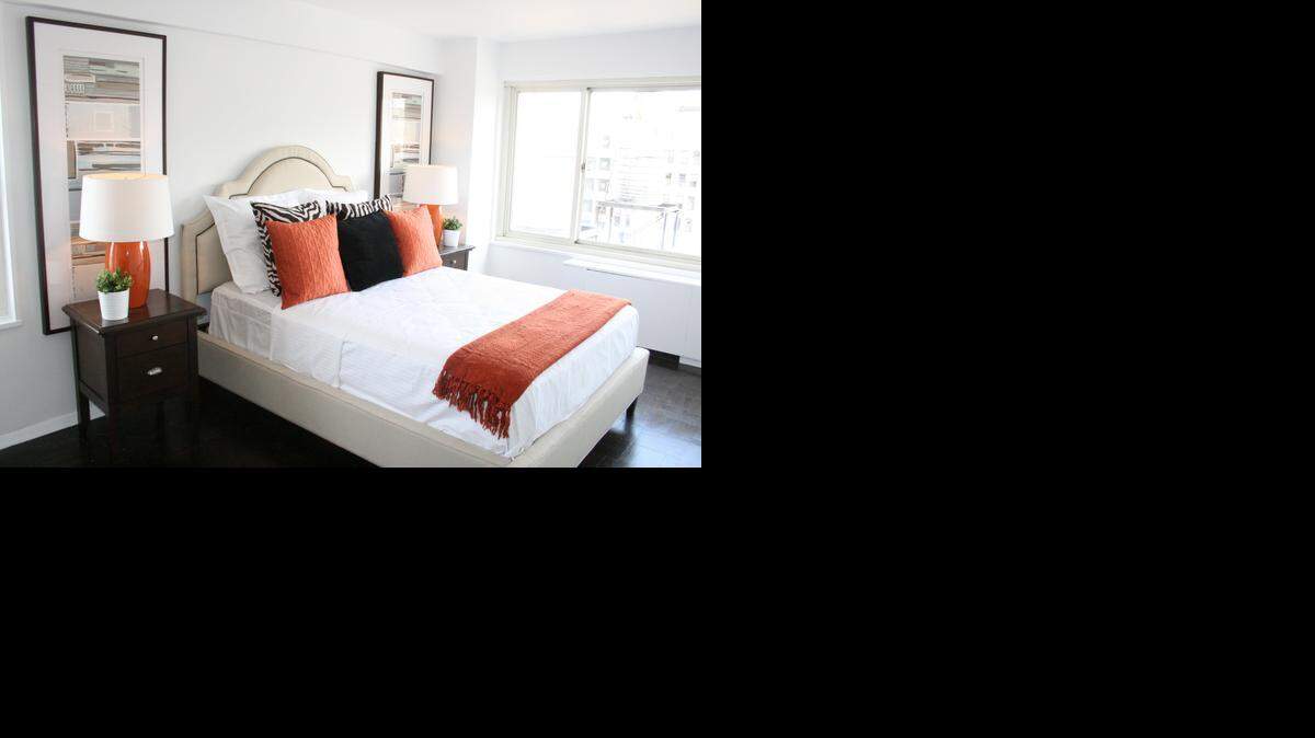 
Bright white and taupe can create a spa-like atmosphere. Don’t be afraid to mix in warm colors, such as a rich orange. 
