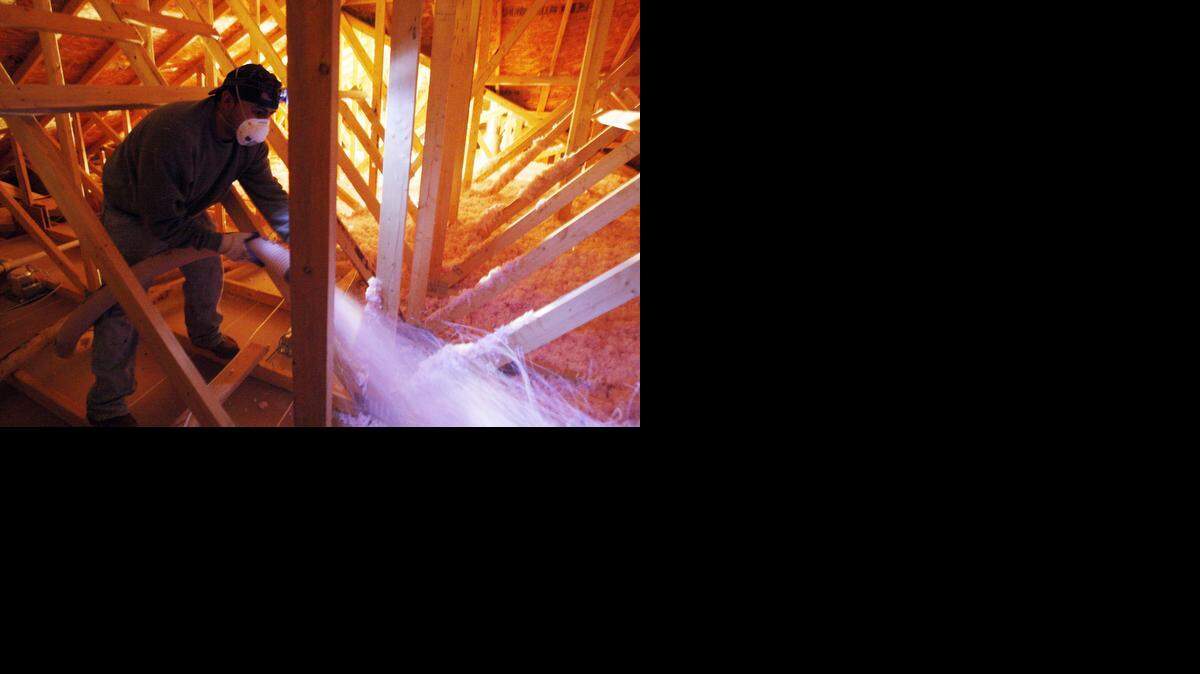 
Insulation is blown in the attic of a home in west Wichita. 
