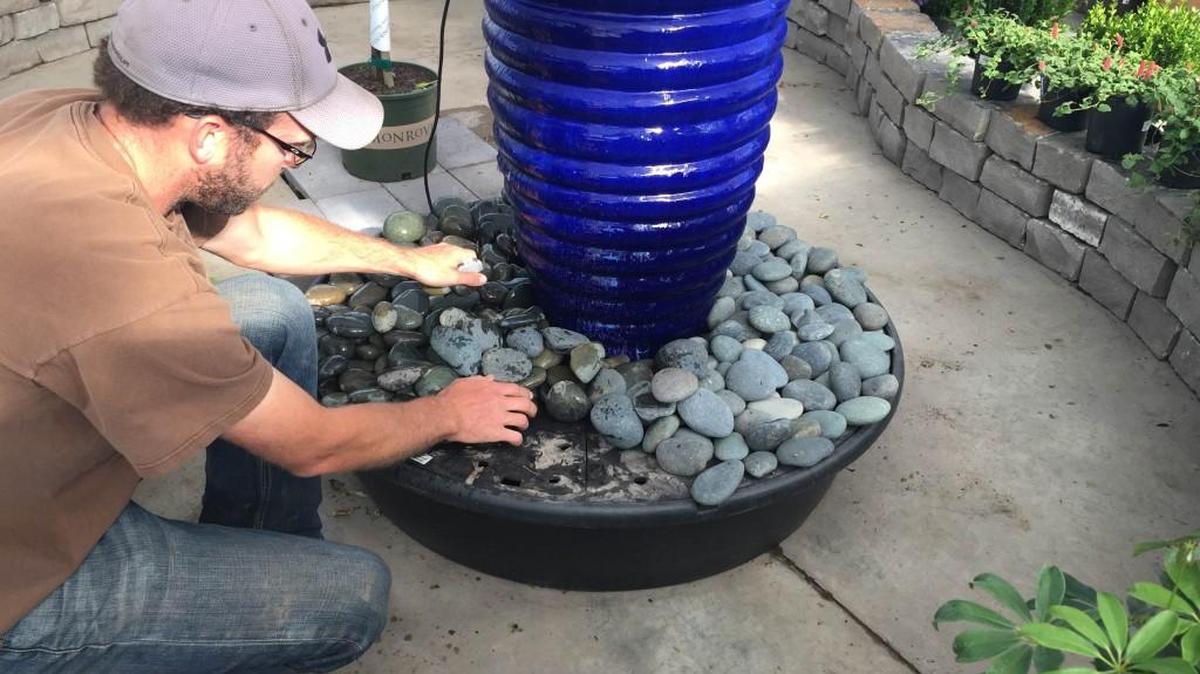 Nathan Polson, a designer at Hong’s, shows how a water basin works.