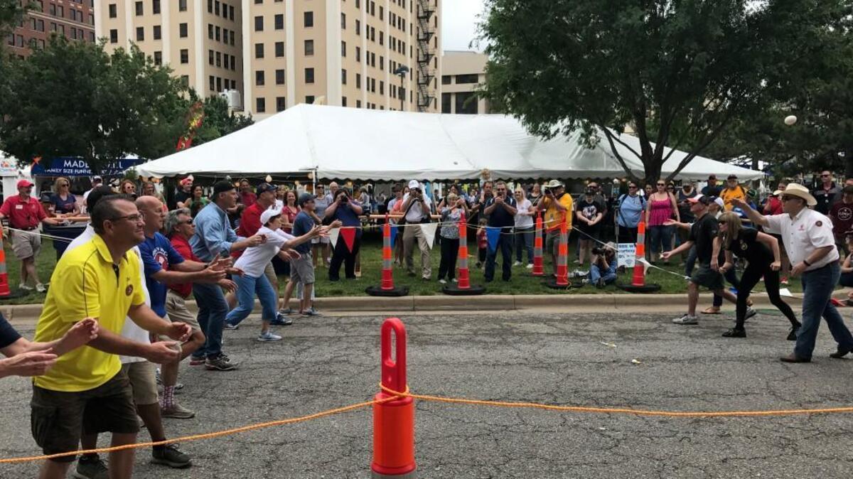 Participants try their hand at tossing and catching a raw egg during the egg toss contest at Riverfest 2017.