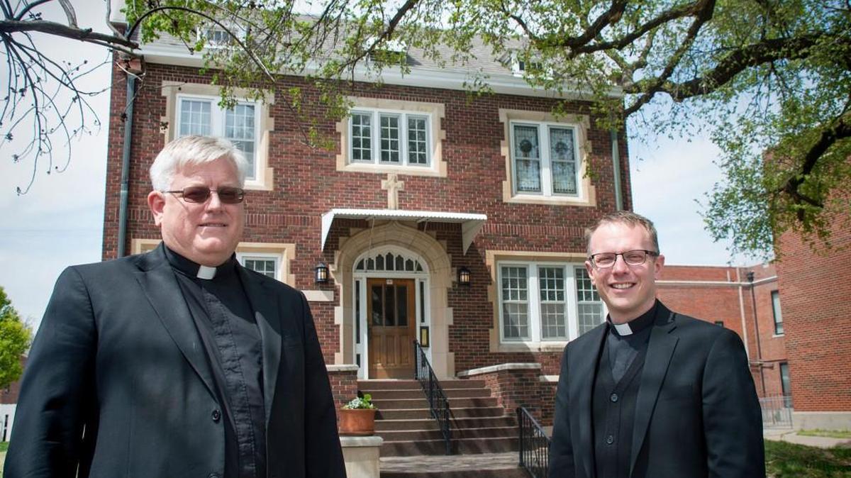 The Rev. Stuart Smeltzer, left, pastor of St. Joseph Parish in Wichita, and the Rev. Michael Simone, director of vocations for the Diocese of Wichita, stand in front of the future St. Joseph House of Formation on the parish campus.