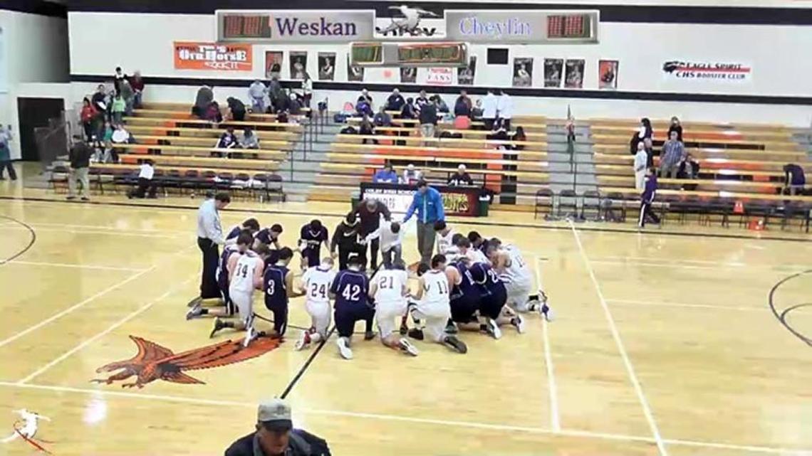 Teams from Cheylin and Weskan pray at a basketball game in January.