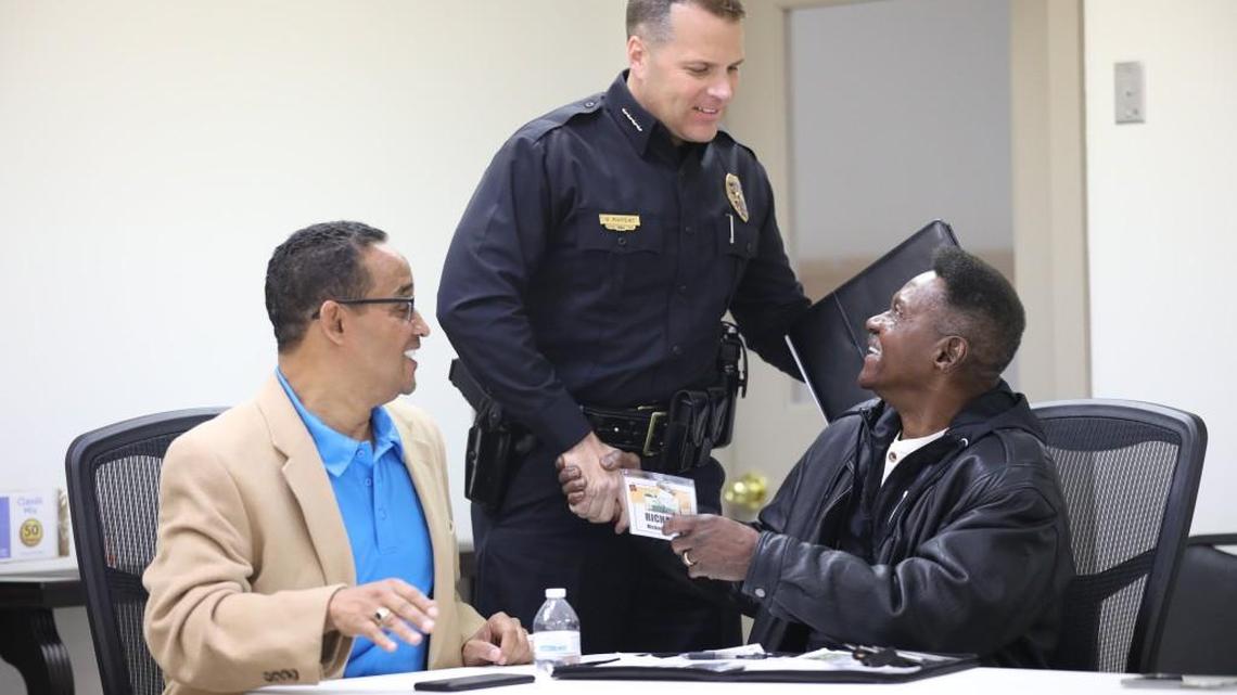 Wichita Police Chief Gordon Ramsay speaks with pastor Richard Woods, right, after a meeting of the “God Squad.” (Dec. 14, 2017)