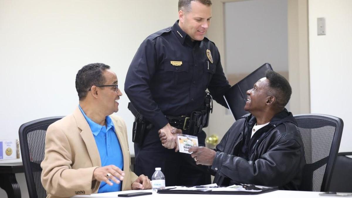 Wichita Police Chief Gordon Ramsay speaks with pastor Richard Woods, right, after a meeting of the “God Squad.” (Dec. 14, 2017)