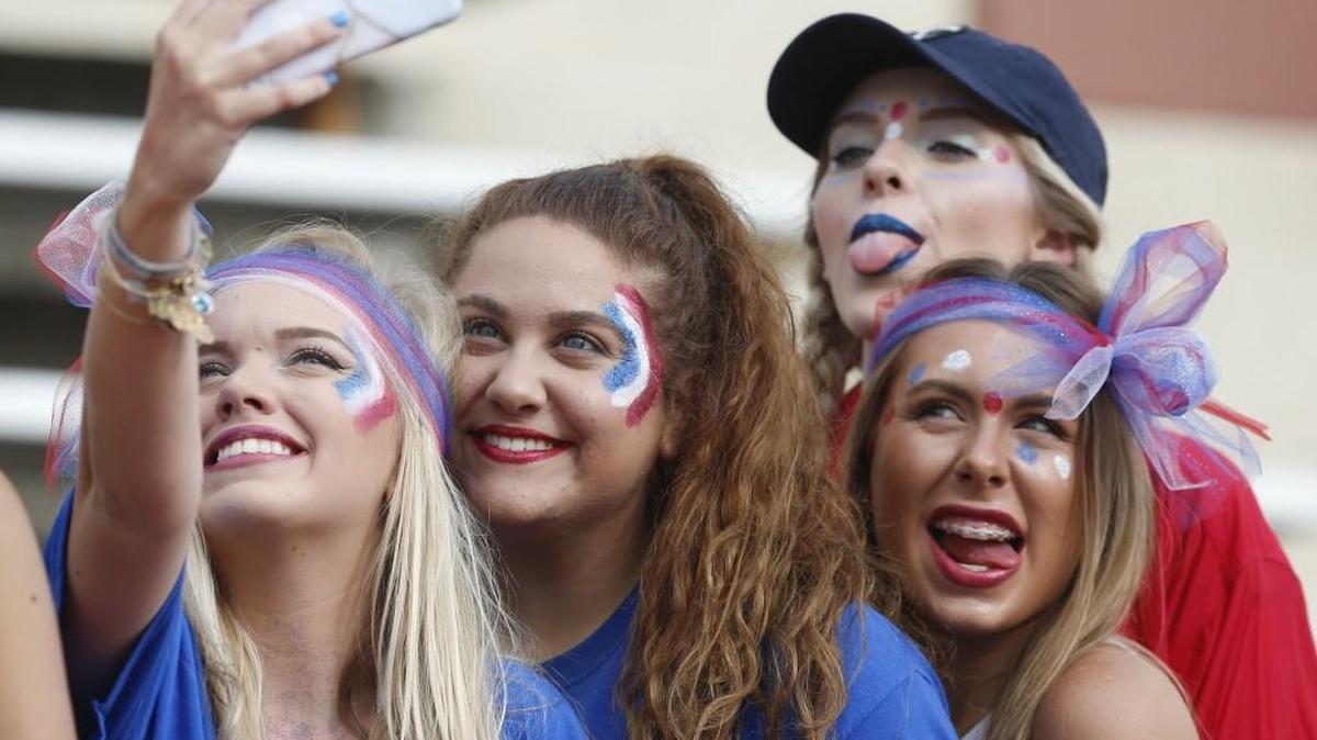 Kapaun students take a selfie before the start of a high school football game with Andover last year.