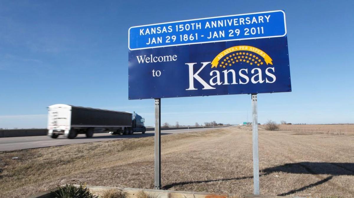 A “Welcome to Kansas” sign at mile marker number 1 on the Kansas Turnpike near the Oklahoma border.