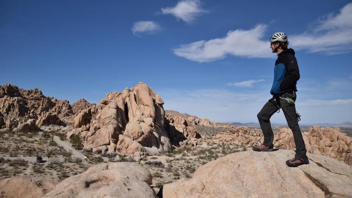Roddy McCalley of Cliffhanger Guides stands on top of Pixie Rock in Joshua Tree National Park.