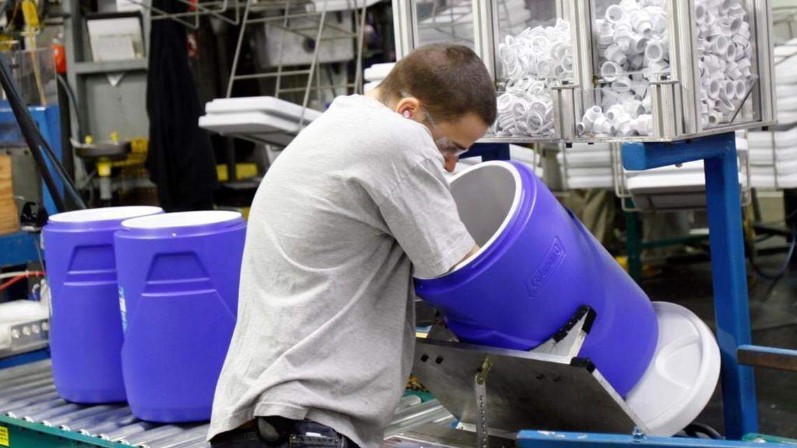 A Coleman Co. employee works on assembling beverage coolers.