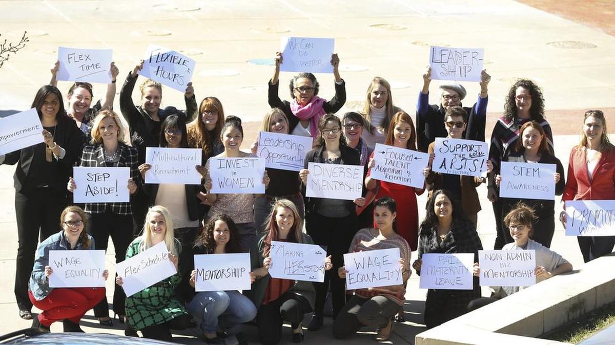 Young professional women of Wichita pose for a group shot of the faces of Wichita’s college-educated workforce. The Eagle asked them to write what they think would make Wichita a better workplace for women.