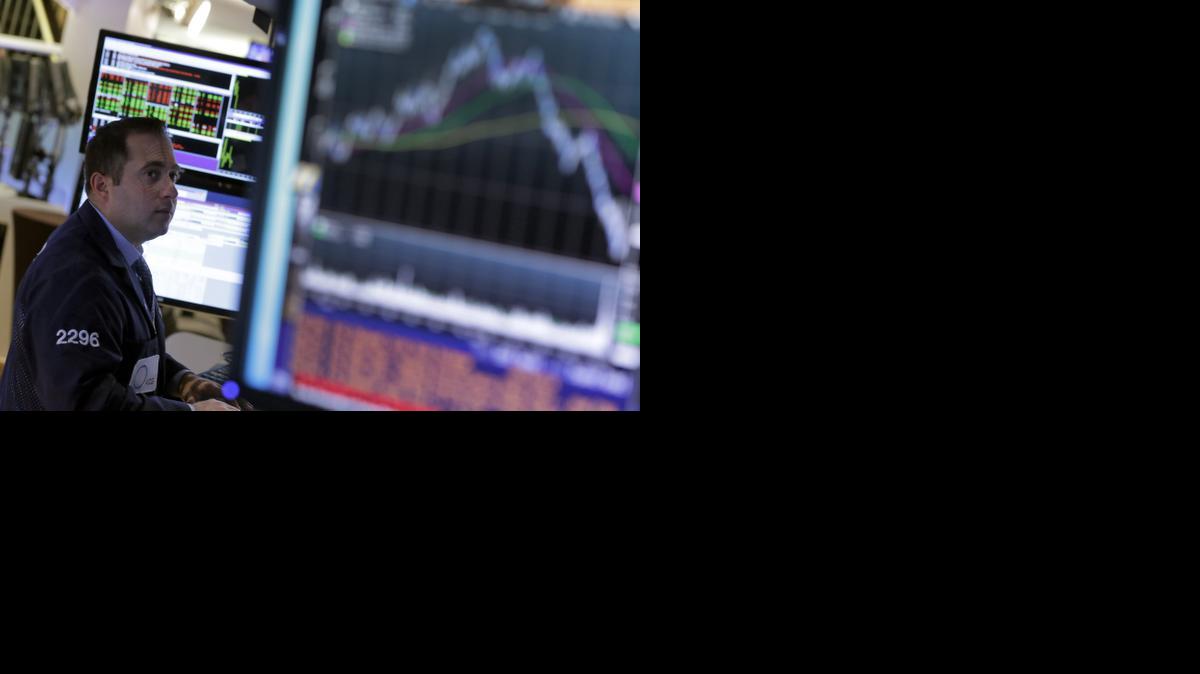 
A specialist works at his post on the floor of the New York Stock Exchange on Wednesday. The market’s sharp losses and gains over the last two weeks have given investors reason to reflect.
