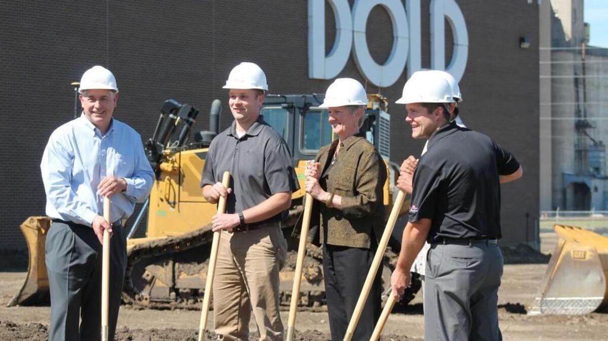 Officials from Dold Foods and Vice Mayor Janet Miller, third from left, formally broke ground Thursday on Dold’s $132 million expansion at its plant at 2929 N. Ohio.